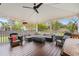 Covered back porch featuring a ceiling fan, wood floors, outdoor seating, and string lights at 1515 Wakendaw Rd, Mount Pleasant, SC 29464