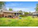 Brick home with a well-maintained backyard, including a grilling area, fire pit, and a screened-in porch at 1515 Wakendaw Rd, Mount Pleasant, SC 29464