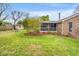 Large backyard with a fire pit, landscaping, a screened-in porch, and a storage shed, surrounded by a fence at 1515 Wakendaw Rd, Mount Pleasant, SC 29464