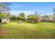 Spacious, grassy backyard includes a fire pit with seating and a storage shed beyond the fenced perimeter at 1515 Wakendaw Rd, Mount Pleasant, SC 29464
