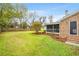 Large backyard with landscaping, a screened-in porch, a storage shed, and a fenced perimeter at 1515 Wakendaw Rd, Mount Pleasant, SC 29464