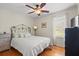 Bedroom features hardwood floors, a ceiling fan, and a large window at 1515 Wakendaw Rd, Mount Pleasant, SC 29464