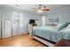 Light blue bedroom with hardwood floors and a large window at 1515 Wakendaw Rd, Mount Pleasant, SC 29464