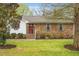 Charming single-story home with a well-maintained lawn, brick facade, and inviting red front door at 1515 Wakendaw Rd, Mount Pleasant, SC 29464