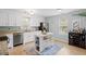 Bright kitchen featuring white cabinets, stainless steel appliances, and an island with seating at 1515 Wakendaw Rd, Mount Pleasant, SC 29464