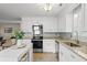 Bright kitchen featuring white cabinets, granite countertops, and stainless steel appliances at 1515 Wakendaw Rd, Mount Pleasant, SC 29464