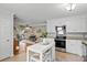 Bright kitchen with white cabinets and an island that opens to the living room at 1515 Wakendaw Rd, Mount Pleasant, SC 29464