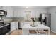 Well-lit kitchen with white cabinets, granite countertops, stainless steel appliances, and a cozy island at 1515 Wakendaw Rd, Mount Pleasant, SC 29464