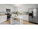 Modern kitchen with white cabinetry, stainless steel appliances, and an island with seating for casual dining at 1515 Wakendaw Rd, Mount Pleasant, SC 29464