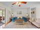Bright living room featuring a plush blue sofa, cozy seating, hardwood floors, and stylish decor at 1515 Wakendaw Rd, Mount Pleasant, SC 29464