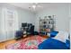 Home office with built in bookshelves, large windows and a colorful rug at 1515 Wakendaw Rd, Mount Pleasant, SC 29464