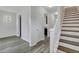 Bright hallway with wood floors and a staircase leading to the upper level at 154 Old Jackson Rd, Goose Creek, SC 29445