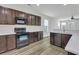 Modern kitchen with stainless steel appliances, dark cabinets, and quartz countertops at 154 Old Jackson Rd, Goose Creek, SC 29445