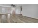 A bright living room with hardwood floors, a ceiling fan and a white door at 154 Old Jackson Rd, Goose Creek, SC 29445