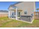 Backyard patio with a hot tub, hanging chair, and partial grass coverage at 159 Lucky Day Dr, Summerville, SC 29486