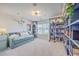 Cozy bonus room features a daybed, a projector, and lots of shelving with books at 159 Lucky Day Dr, Summerville, SC 29486