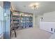 Upstairs bonus room features wall to wall bookshelves and carpet at 159 Lucky Day Dr, Summerville, SC 29486