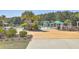 Community pool and splashpad with many umbrellas, chairs, and lounge seating at 159 Lucky Day Dr, Summerville, SC 29486