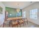 Bright dining room with chandelier lighting, modern wall decor and large windows at 159 Lucky Day Dr, Summerville, SC 29486
