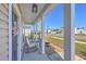 Welcoming covered front porch with rocking chairs, hanging lantern and decorative wreath at 159 Lucky Day Dr, Summerville, SC 29486