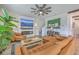 Bright living room featuring a fireplace, a TV, stylish decor and tan leather furniture at 159 Lucky Day Dr, Summerville, SC 29486