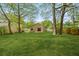 Spacious backyard with a well-kept lawn, mature trees, and a patio area, providing an ideal space for outdoor activities at 160 Mickler Dr, Ladson, SC 29456