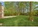 Expansive backyard featuring lush lawn, mature trees, and a concrete patio, perfect for outdoor relaxation and entertaining at 160 Mickler Dr, Ladson, SC 29456