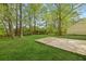 Lush backyard with a concrete patio, mature trees, and plenty of space for outdoor activities at 160 Mickler Dr, Ladson, SC 29456