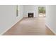 Spacious and bright living room with hardwood floors, a fireplace, and large windows at 160 Mickler Dr, Ladson, SC 29456