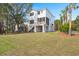 Spacious backyard featuring a screened porch, a large grassy area and multiple mature trees at 1615 Macoma Rd, Mount Pleasant, SC 29466