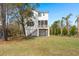 Backyard featuring a screened porch, a grassy area and mature trees and landscaping at 1615 Macoma Rd, Mount Pleasant, SC 29466