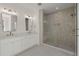Bright bathroom features a double vanity and a glass enclosed tiled shower with a built-in seat at 1615 Macoma Rd, Mount Pleasant, SC 29466