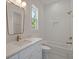 Bright bathroom with white vanity, gold fixtures, and scalloped tile accents at 1615 Macoma Rd, Mount Pleasant, SC 29466