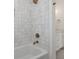 Bathroom with shower and tub with modern fixtures, featuring white tiling and bronze showerhead at 1615 Macoma Rd, Mount Pleasant, SC 29466