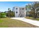 Beautifully landscaped home with a long driveway leading up to the attached garages and front entry at 1615 Macoma Rd, Mount Pleasant, SC 29466
