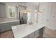 Bright kitchen with stainless steel refrigerator, white countertops, and hanging pendant lights at 1615 Macoma Rd, Mount Pleasant, SC 29466