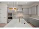 Stylish kitchen with a quartz countertop island, pendant lighting, and stainless steel appliances at 1615 Macoma Rd, Mount Pleasant, SC 29466