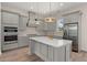 Modern kitchen featuring a large island with a quartz countertop, stainless steel appliances, and custom cabinetry at 1615 Macoma Rd, Mount Pleasant, SC 29466