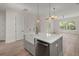 Charming kitchen island with a white quartz countertop, a modern faucet, and an open view to the dining area at 1615 Macoma Rd, Mount Pleasant, SC 29466