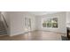 Living room featuring fireplace, staircase, French doors to deck, window, and light wood floors at 1615 Macoma Rd, Mount Pleasant, SC 29466