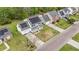 Aerial view of homes with solar panels, green lawns, driveways, and surrounding trees at 176 Hainsworth Dr, North Charleston, SC 29418