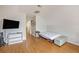 Cozy bedroom space with light walls and wood-look floors plus a TV and hallway access at 176 Hainsworth Dr, North Charleston, SC 29418