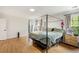 Bright bedroom featuring hardwood floors, a four-poster bed, and ample natural light at 176 Hainsworth Dr, North Charleston, SC 29418