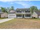Charming two-story home featuring a welcoming front porch and solar panels on the roof at 176 Hainsworth Dr, North Charleston, SC 29418