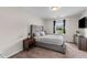 Bedroom with a large gray upholstered bed, matching furniture, and a window view at 178 Buchanan Cir, Goose Creek, SC 29445