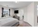 This cozy bedroom has a large TV mounted to the wall and a window view at 178 Buchanan Cir, Goose Creek, SC 29445