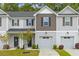 Charming townhome featuring attached garage, manicured lawn, and modern design elements at 178 Buchanan Cir, Goose Creek, SC 29445
