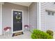Inviting front door adorned with a seasonal wreath and potted flowers creating a warm welcome at 178 Buchanan Cir, Goose Creek, SC 29445