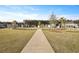 A sidewalk leads to well maintained homes in this planned community featuring palm trees and vibrant landscaping at 183 Country Gate Lane Ln, Summerville, SC 29485