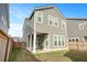 Exterior view of a two-story home with green siding and multiple windows, showcasing the well-maintained backyard at 183 Country Gate Lane Ln, Summerville, SC 29485